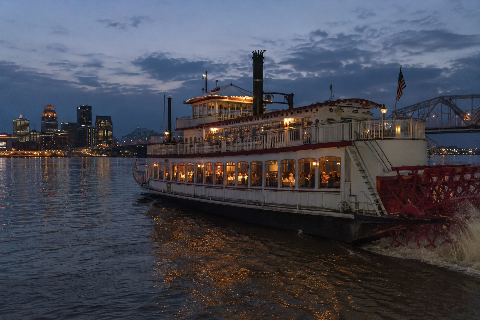 A large paddle steamer riverboat serving a formal dinner on the Ohio River in Louisville, Kentucky.